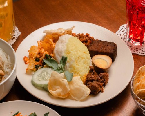 A plate of traditional Indonesian mixed rice with vegetables and tempeh