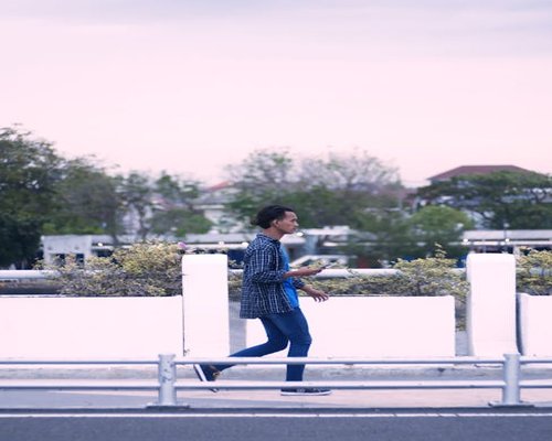 Person walking comfortably on a pedestrian path in an Indonesian city